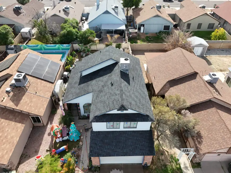 The same house after replacement with dark gray shingles.